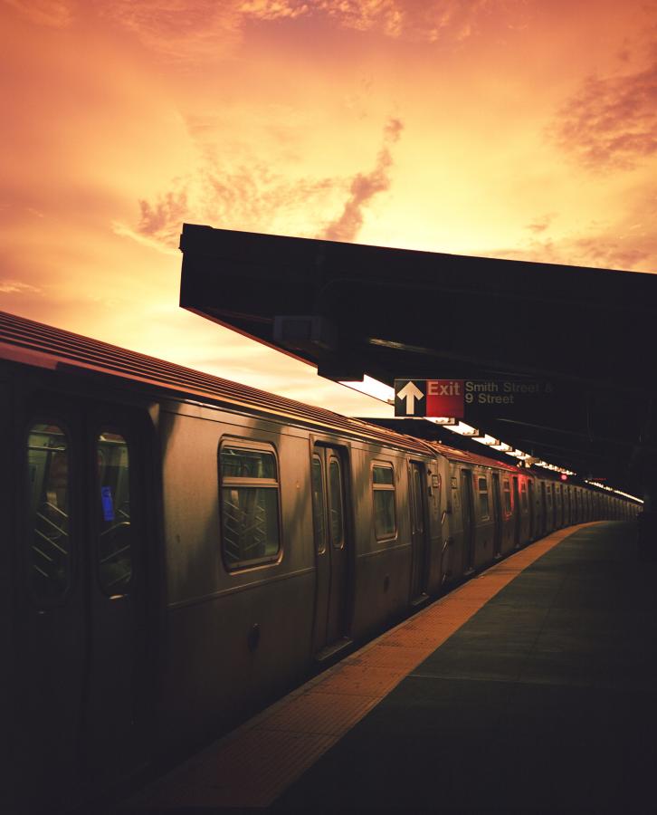 A shot of a subway train at sunset in New York City