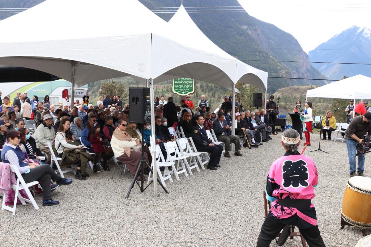Audience sits under tents during taiko performance at East Lillooet Memorial Garden