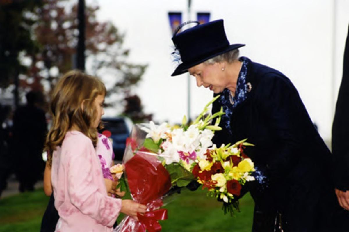 Queen Elizabeth accepting flowers from child during Royal Jubilee visit to UBC