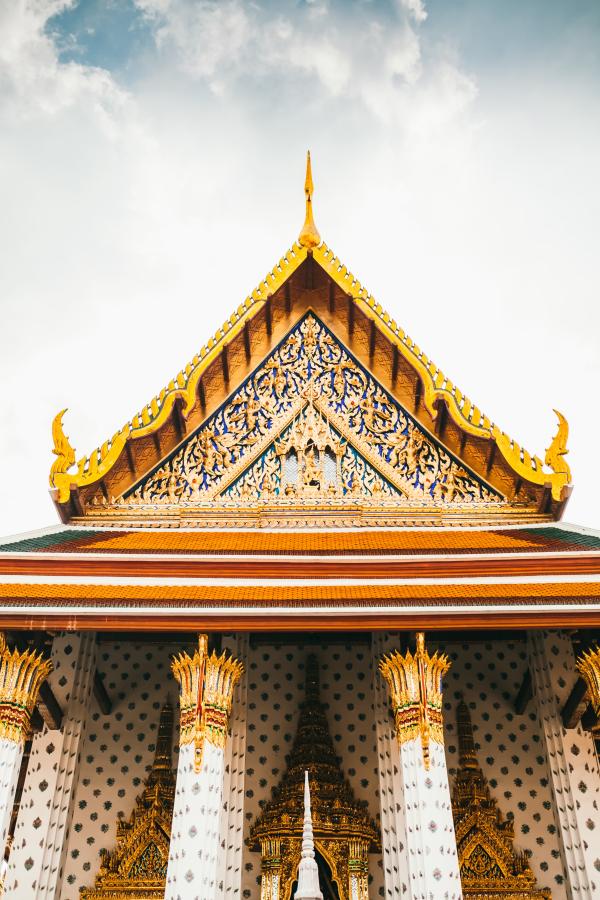 Upper portion of Grand Palace, showing gilded, triangular roof atop four columns