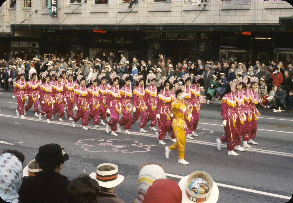 The Vancouver Chinese Girls' Drill Team marching on the street