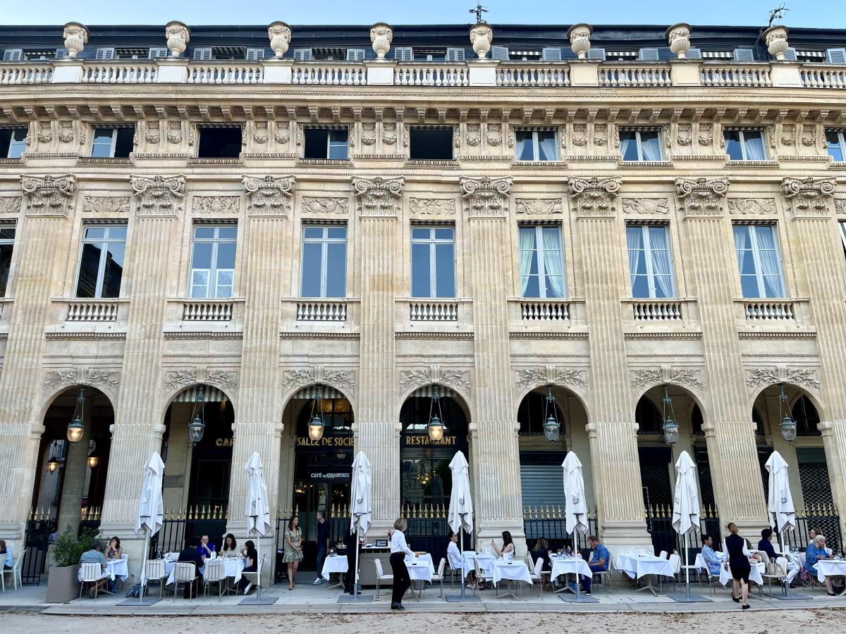 Wide-angle shot of Palais Royal showing building arches and outdoor tables