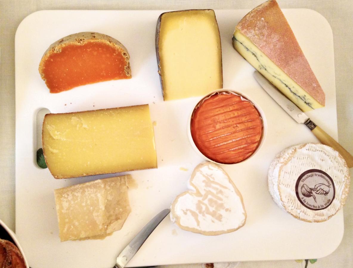 Overhead shot of various cheeses on a plate