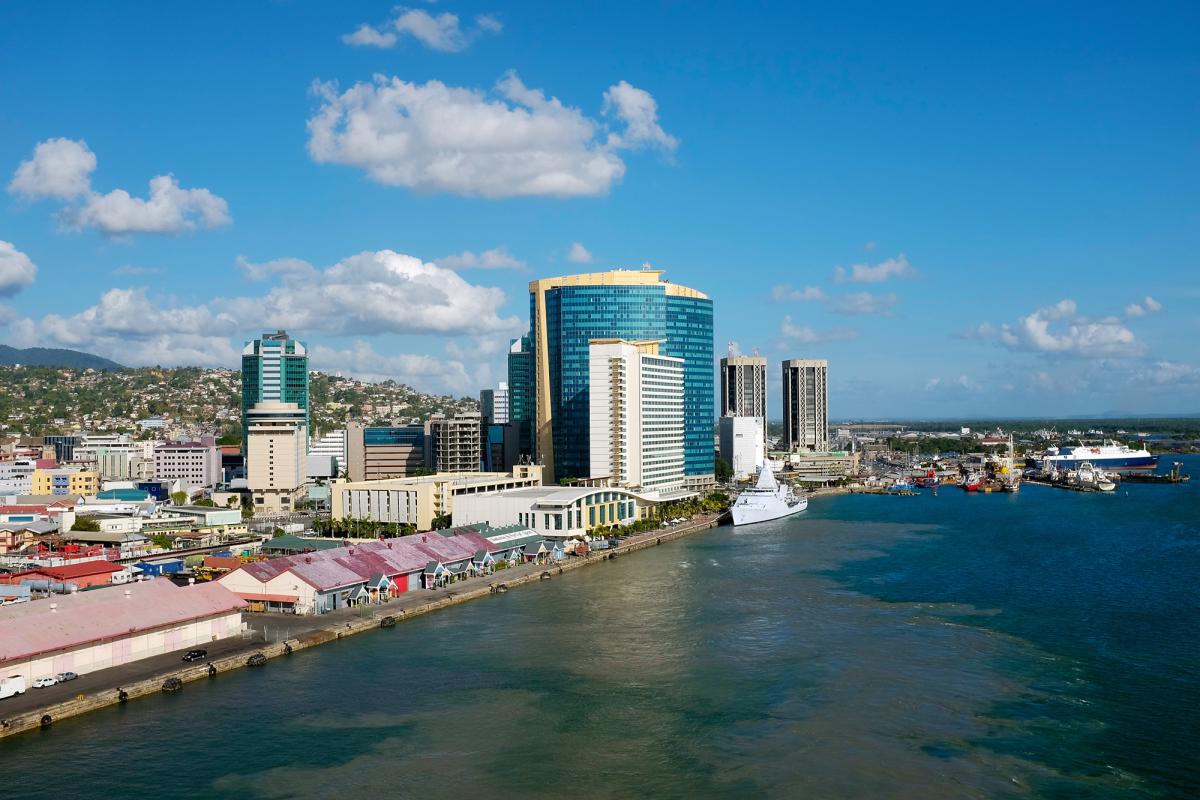 Wide-angle shot of Port of Spain showing buildings on the left and water on the right