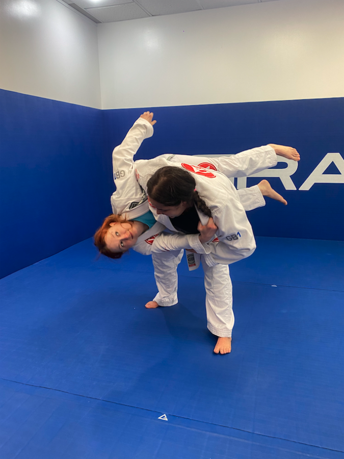 Alex Chessman practicing jiu-jitsu with another UBC alum