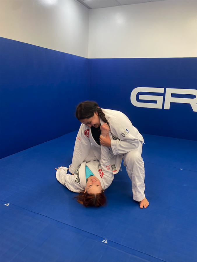 Alex Chessman practicing jiu-jitsu with another UBC alum