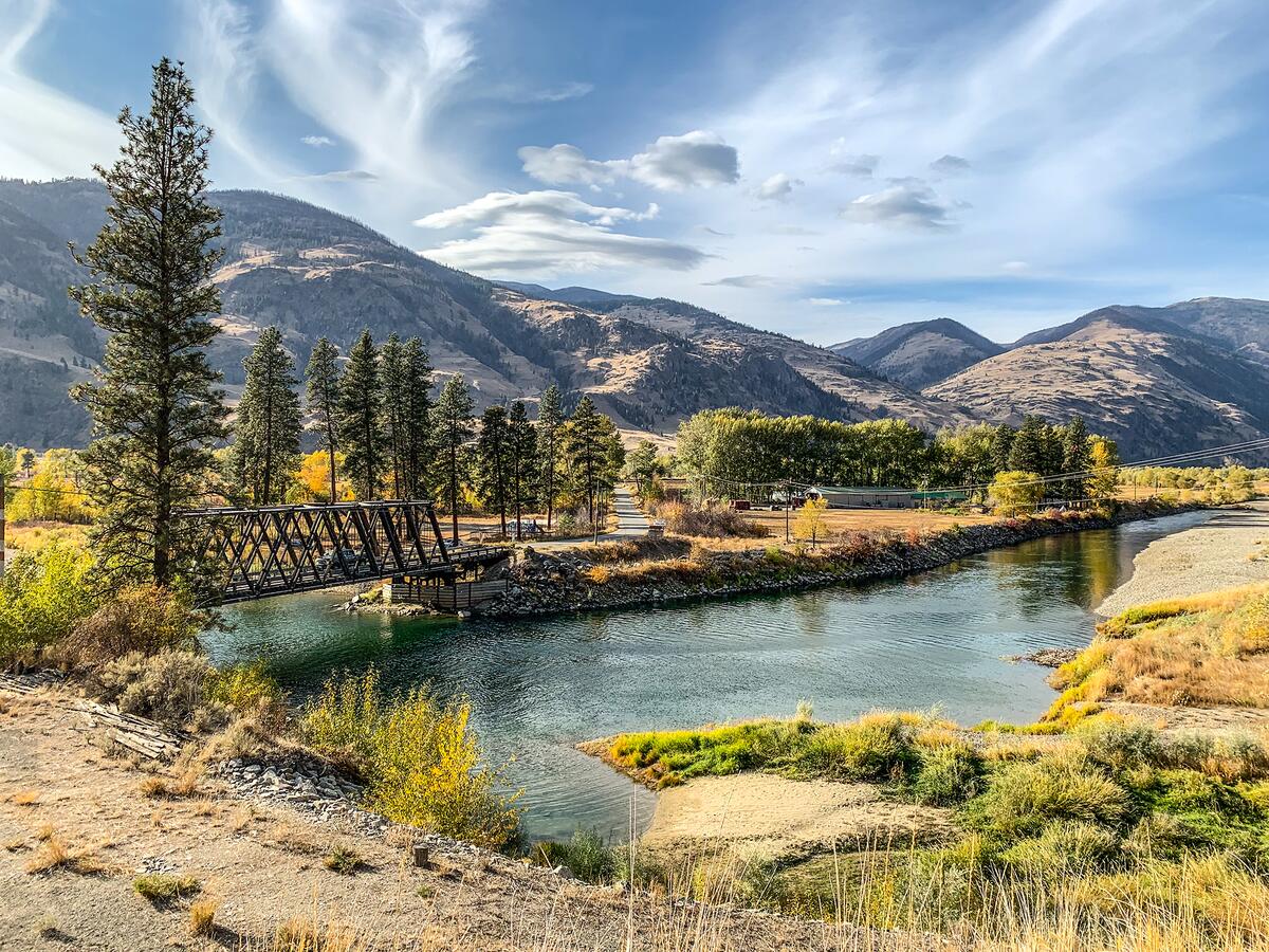 A wide-angle shot of the Similkameen River, with the Chopaka Bridge on the left