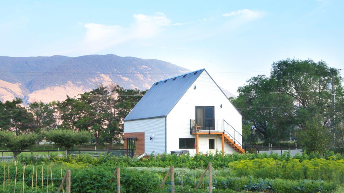 The Farm Store on Honest Food Farm, with mountains and greenery in the background