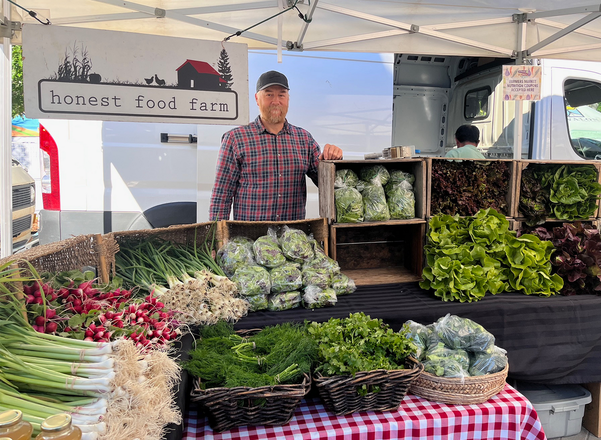 Yuri Zebroff selling fresh produce from his farm at a local farmer's market