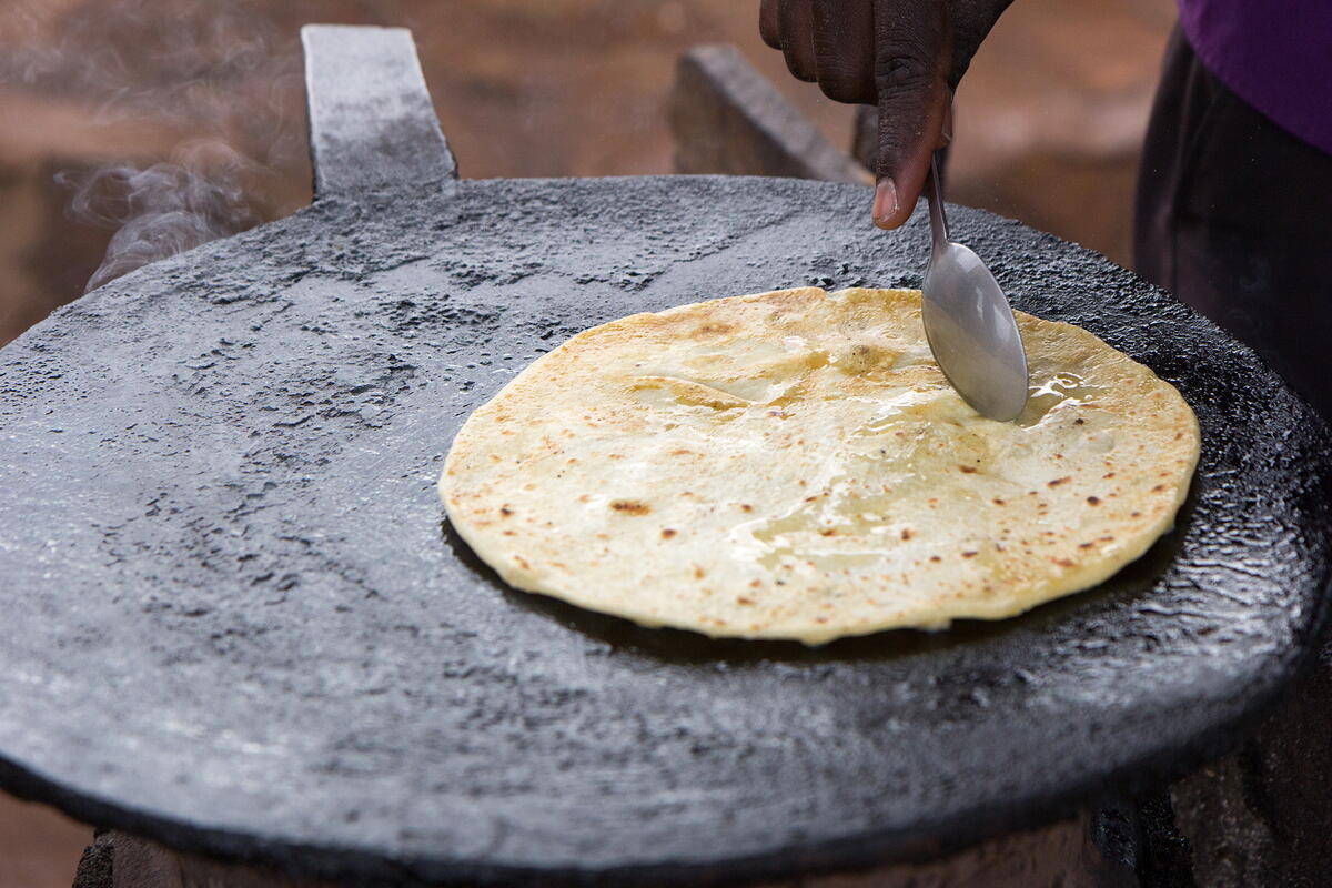 Chapati (flatbread) being fried with a spoon