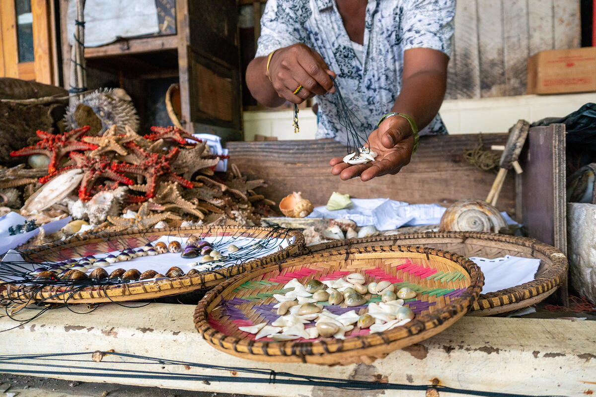 A person selling shells at a fish market in Dar es Salaam