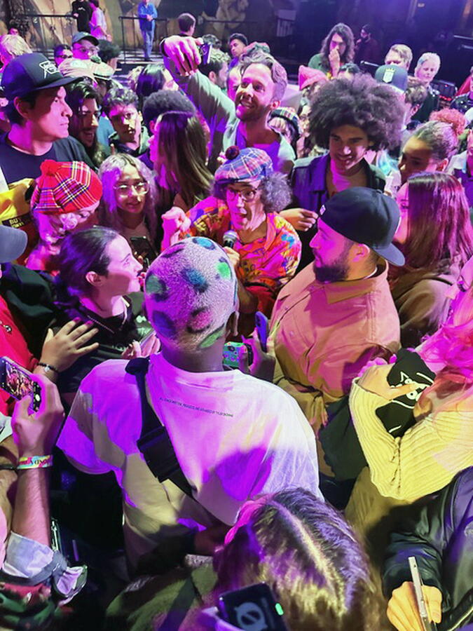 Nardwuar mingling in a crowd of fans