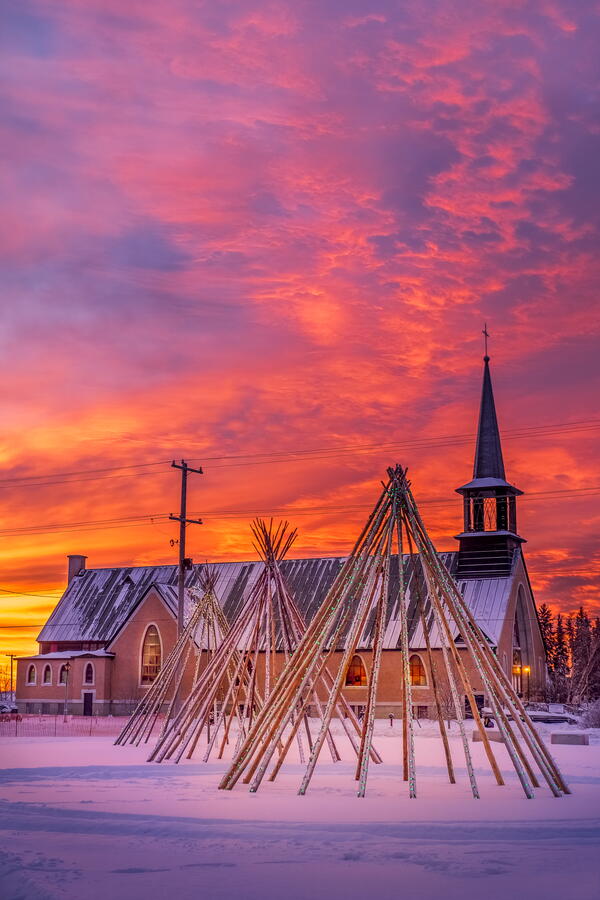 A gorgeous sunset in Fort Smith, with the Salt River First Nation teepees in the foreground and St. Joseph's Cathedral in the background.