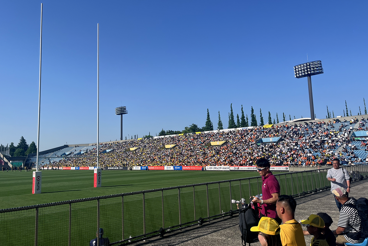 Wide-angle shot of a rugby game in Tokyo on a blue-sky day