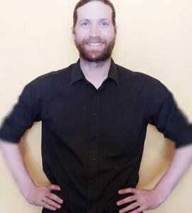 A photo of Freeman Portiz wearing a black collared shirt
