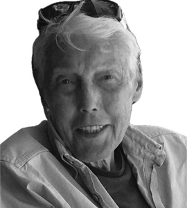 A black and white portrait of James Edward Currie with sunglasses on top of his head.