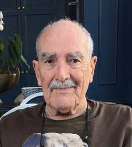 A photo of Robert Woodward wearing a brown sweatshirt.