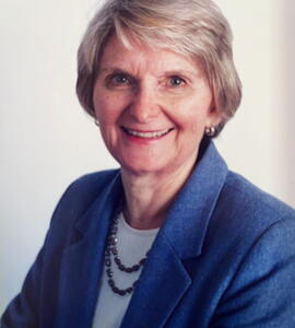A photo of Catherine Jane Lingas with short white hair and a blue blazer.