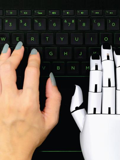 Human left hand beside a robotic right hand
