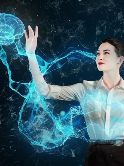 Woman holding her hand up to a holographic brain