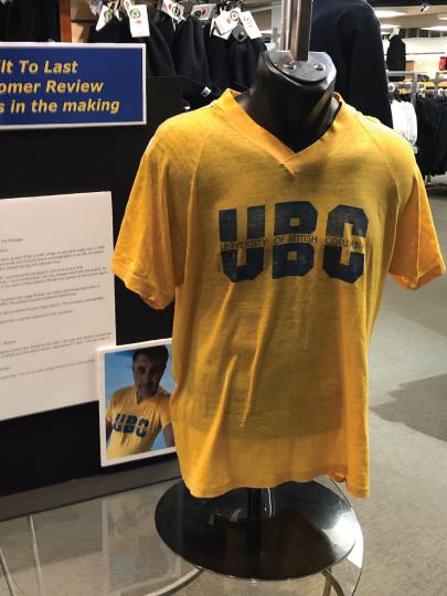 Old yellow UBC t-shirt displayed on mannequin 