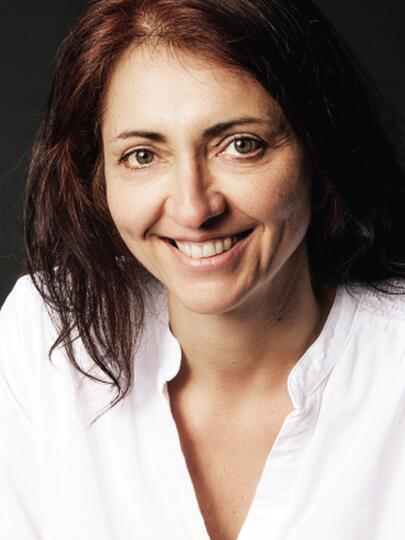 Headshot of Dr. Kalina Christoff smiling against a dark background