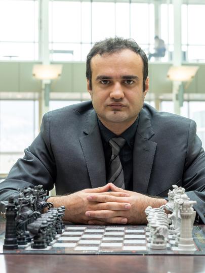 Dr. Amir Ardestani-Jaafari sits at a table with a chessboard