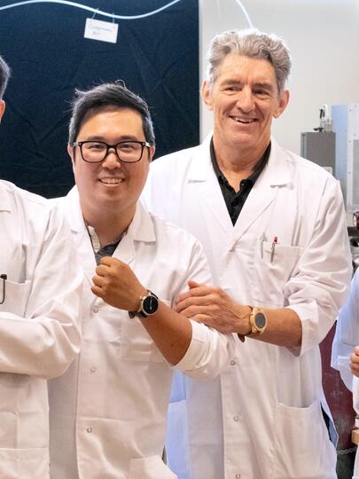 Four researchers, with three displaying watches on their wrists