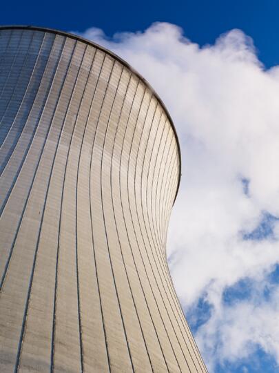 A nuclear reactor tower against the blue sky.