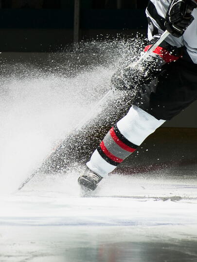 Two hockey players compete on the ice