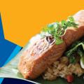 Photo of glazed salmon against a yellow and blue background.
